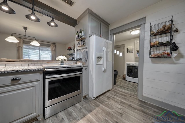 kitchen featuring visible vents, washer / dryer, stainless steel electric range, light wood-style floors, and white fridge with ice dispenser