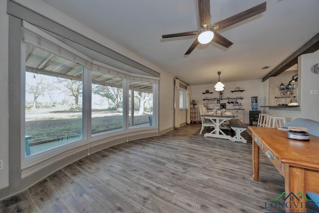 dining room featuring ceiling fan and wood finished floors