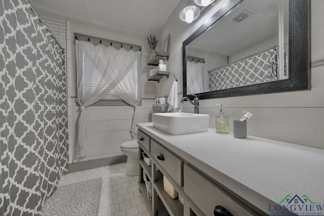 bathroom featuring visible vents, toilet, a shower with shower curtain, tile patterned flooring, and vanity