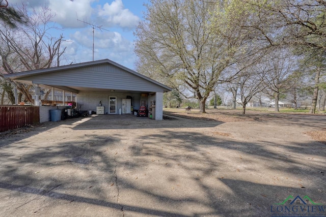 view of home's exterior with a carport and driveway