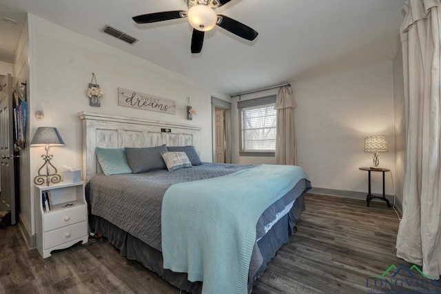 bedroom with baseboards, wood finished floors, visible vents, and ceiling fan