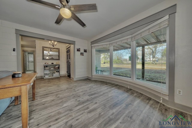 unfurnished sunroom featuring ceiling fan