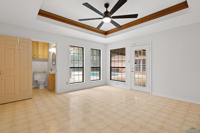 1307 Spring Tree Ln, Kilgore, TX 75662 - spare room with a tray ceiling, ceiling fan, and baseboards