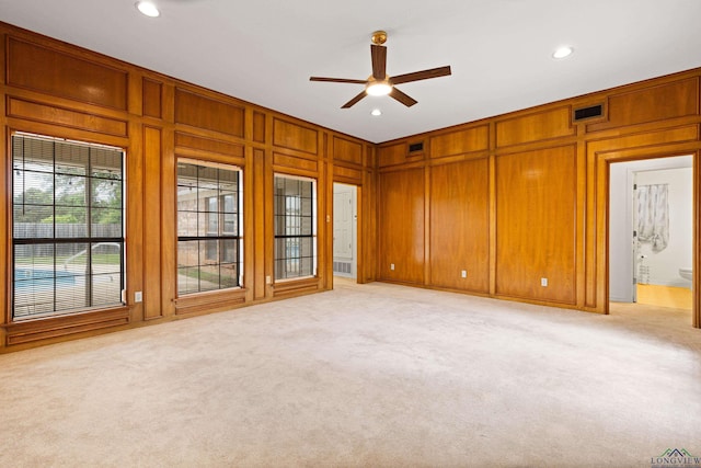 1307 Spring Tree Ln, Kilgore, TX 75662 - unfurnished room with ceiling fan, light colored carpet, recessed lighting, and wood walls
