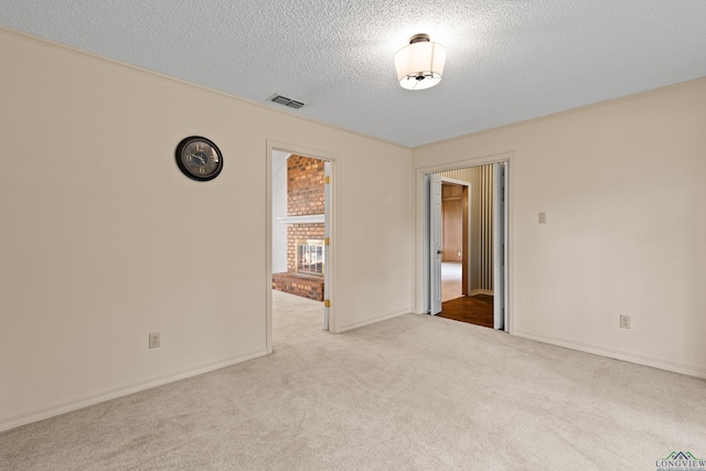 1307 Spring Tree Ln, Kilgore, TX 75662 - carpeted empty room with a textured ceiling and baseboards