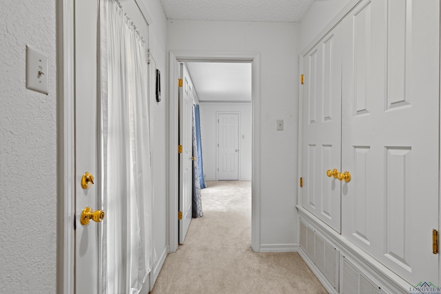 1307 Spring Tree Ln, Kilgore, TX 75662 - hall with light carpet and a textured ceiling