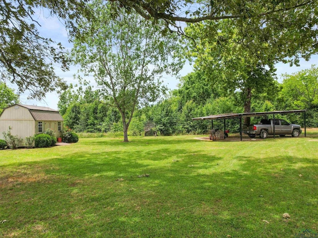 3506 Dudley Rd, Kilgore, TX 75662 - view of green lawn with a detached carport and an outdoor structure