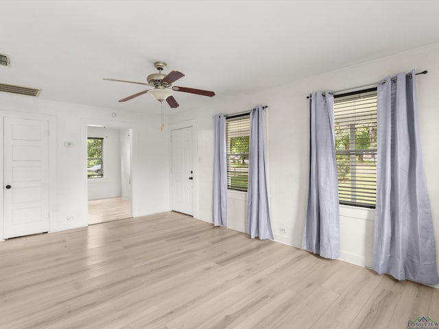 3506 Dudley Rd, Kilgore, TX 75662 - unfurnished room with light wood finished floors, healthy amount of natural light, and ceiling fan