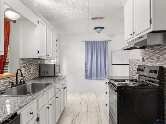 3506 Dudley Rd, Kilgore, TX 75662 - kitchen with electric range, under cabinet range hood, stainless steel microwave, a sink, and white cabinets