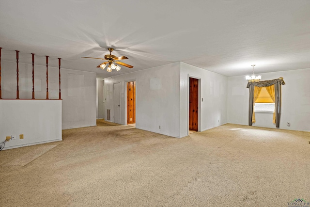 unfurnished room featuring carpet floors and ceiling fan with notable chandelier