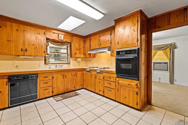 kitchen featuring a skylight, sink, cooling unit, light colored carpet, and black appliances