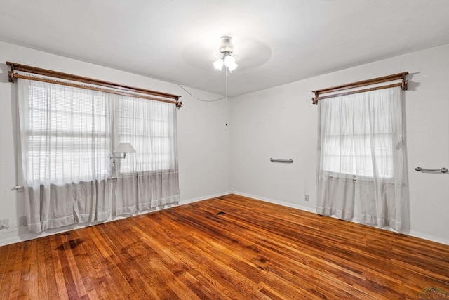 empty room featuring wood-type flooring and ceiling fan