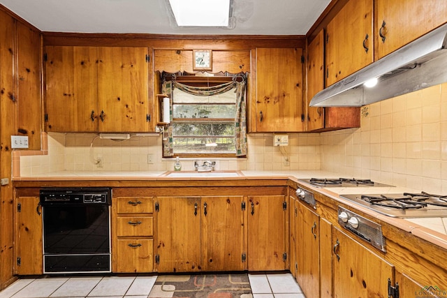 kitchen with backsplash, dishwasher, light tile patterned flooring, and sink