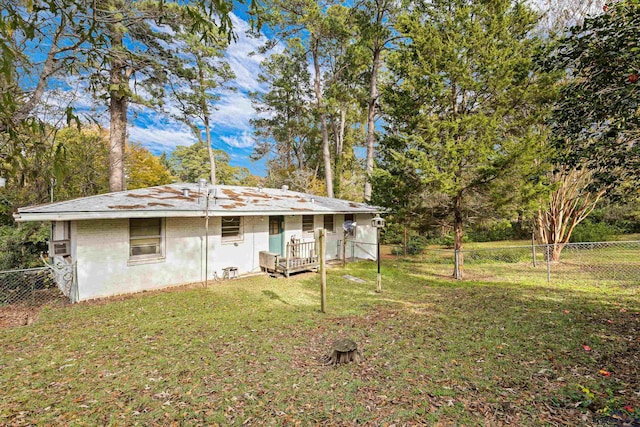 rear view of house featuring a lawn