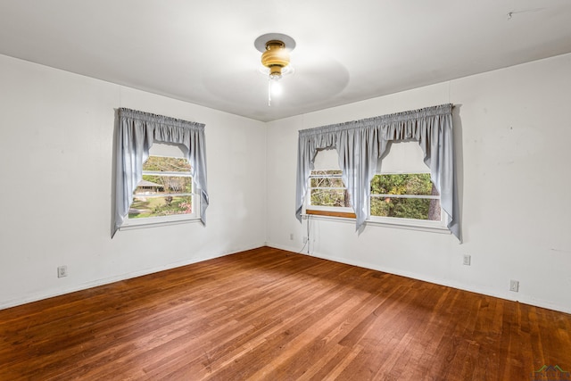 empty room featuring hardwood / wood-style flooring and a healthy amount of sunlight