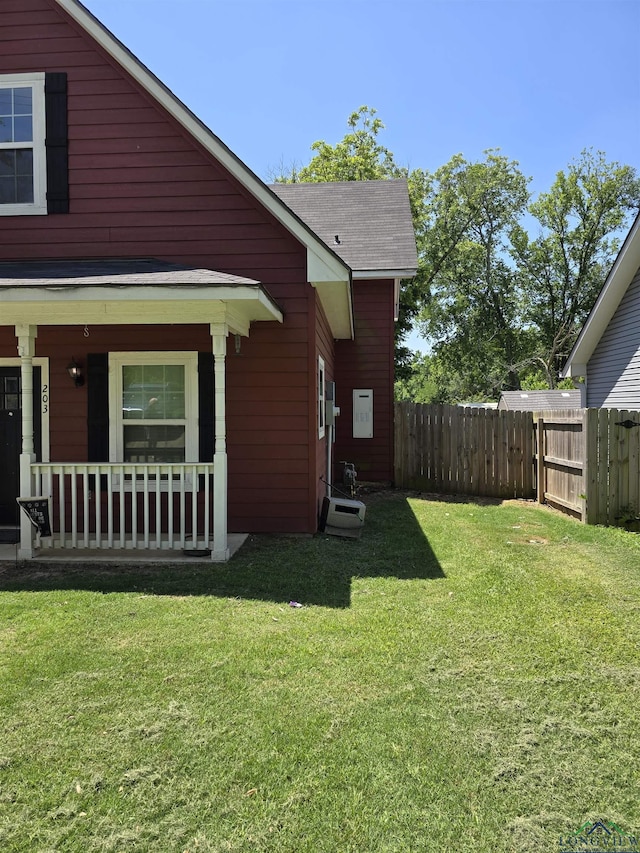 203 W Gay Ave, Gladewater, TX 75647 - view of side of property with a shingled roof and a porch
