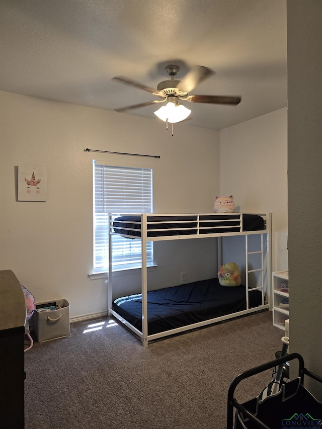 203 W Gay Ave, Gladewater, TX 75647 - bedroom with carpet flooring, a ceiling fan, and baseboards