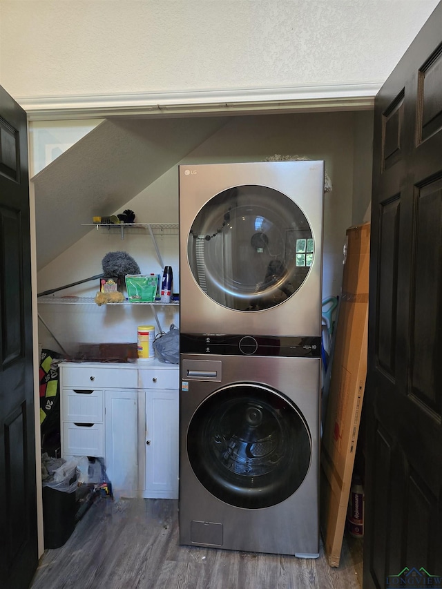 203 W Gay Ave, Gladewater, TX 75647 - washroom featuring estacked washer and dryer and wood finished floors