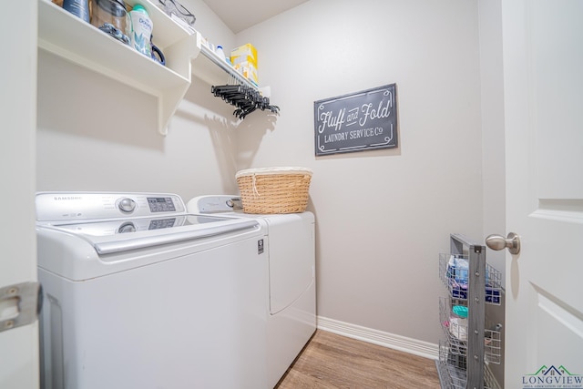 laundry room featuring washer and dryer and light wood-type flooring