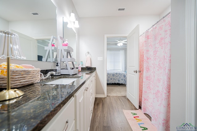 bathroom featuring hardwood / wood-style flooring, vanity, and ceiling fan