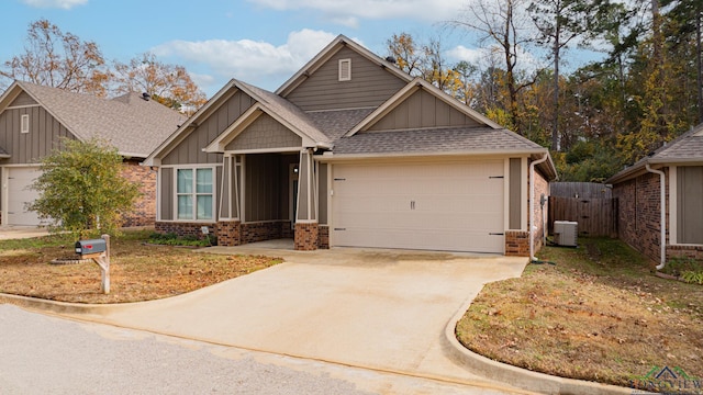 craftsman inspired home with central air condition unit and a garage