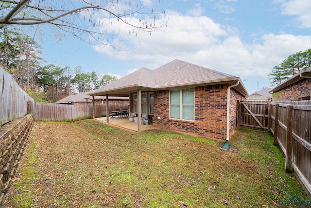 back of property with a patio and a lawn