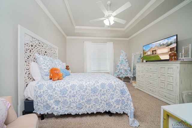 carpeted bedroom with a tray ceiling, ceiling fan, and ornamental molding