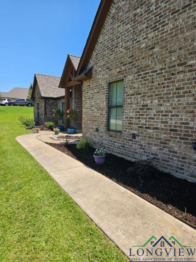 240 Cedar Ridge Rd, Longview, TX 75602 - view of side of home with a lawn and brick siding