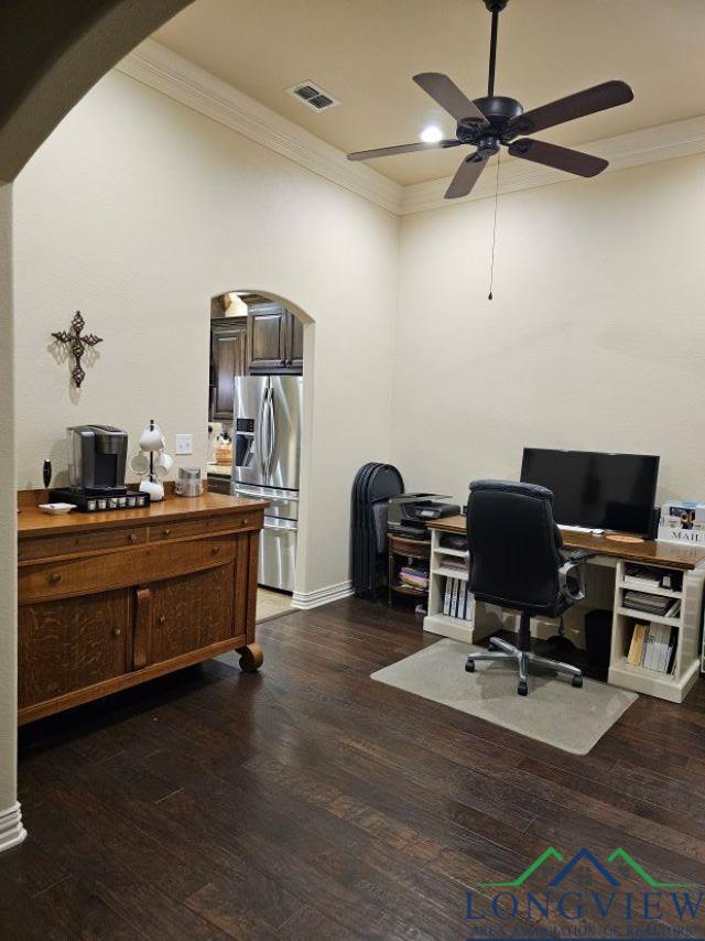 240 Cedar Ridge Rd, Longview, TX 75602 - home office featuring arched walkways, crown molding, a ceiling fan, dark wood-style floors, and baseboards