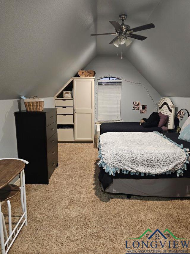 240 Cedar Ridge Rd, Longview, TX 75602 - bedroom with vaulted ceiling, light colored carpet, and ceiling fan