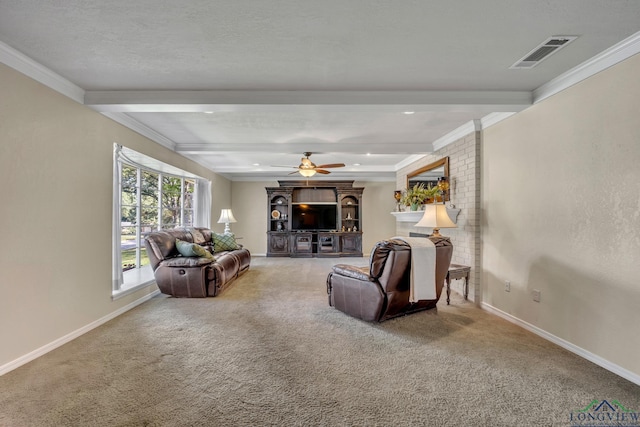 carpeted living room with ceiling fan, beam ceiling, ornamental molding, and a textured ceiling