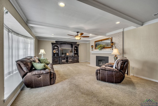 carpeted living room with beamed ceiling, ceiling fan, crown molding, and a fireplace