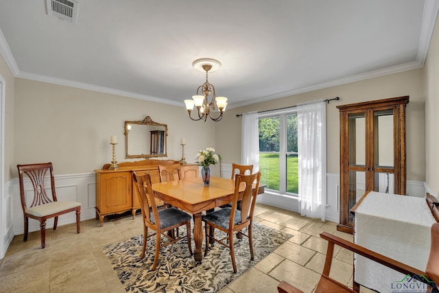 dining room with ornamental molding and an inviting chandelier