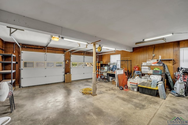 garage featuring wood walls and a garage door opener