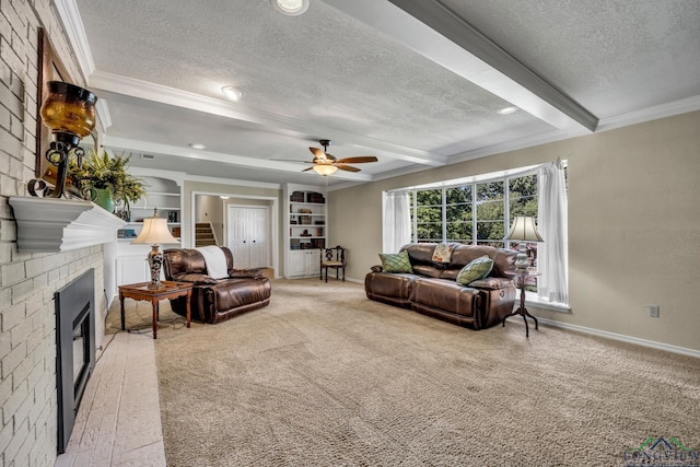 carpeted living room featuring a textured ceiling, ceiling fan, beam ceiling, built in features, and a fireplace