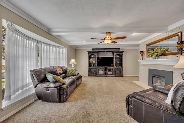 carpeted living room featuring ceiling fan, a brick fireplace, beamed ceiling, crown molding, and a textured ceiling