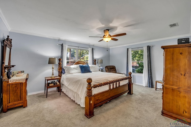 carpeted bedroom featuring multiple windows, ceiling fan, and ornamental molding