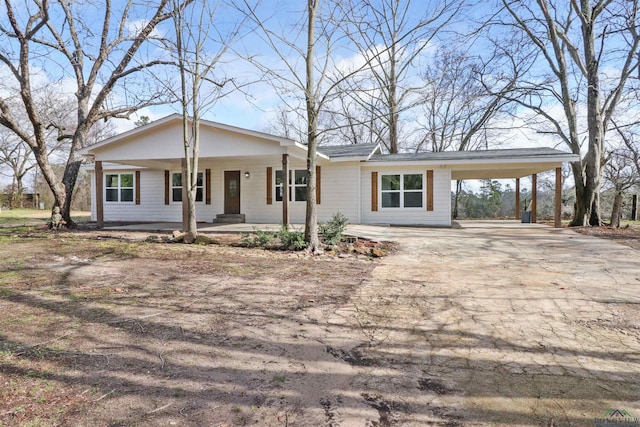 ranch-style home with a porch and a carport