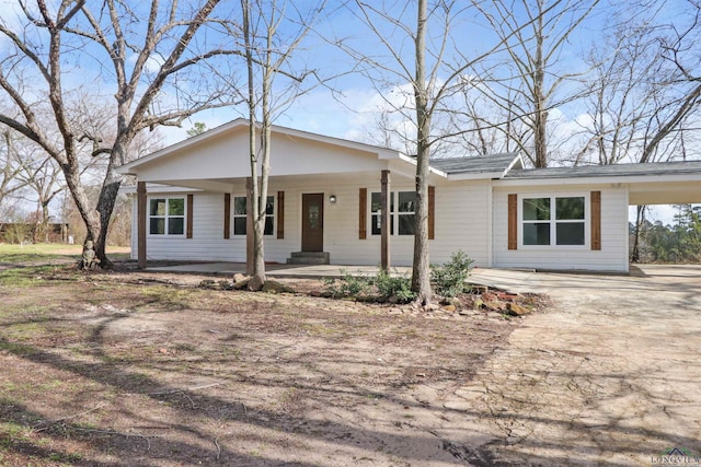 single story home with a carport and covered porch