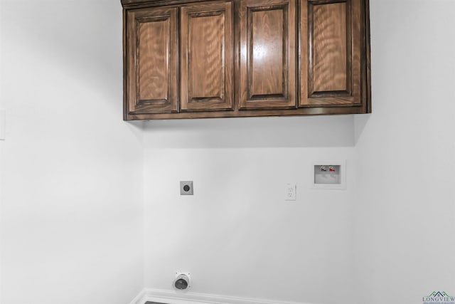 clothes washing area with washer hookup, cabinets, and hookup for an electric dryer