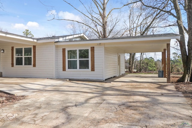 view of side of home with a carport