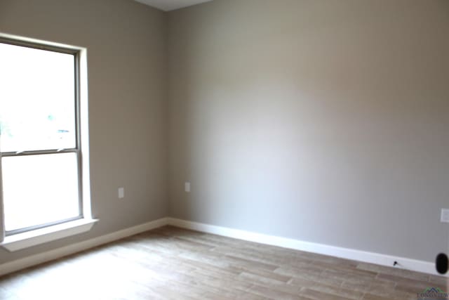 unfurnished room with light wood-type flooring