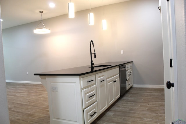 kitchen with white cabinetry, sink, dishwasher, hanging light fixtures, and dark hardwood / wood-style floors