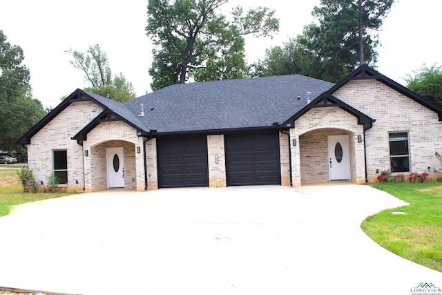 french provincial home with a garage