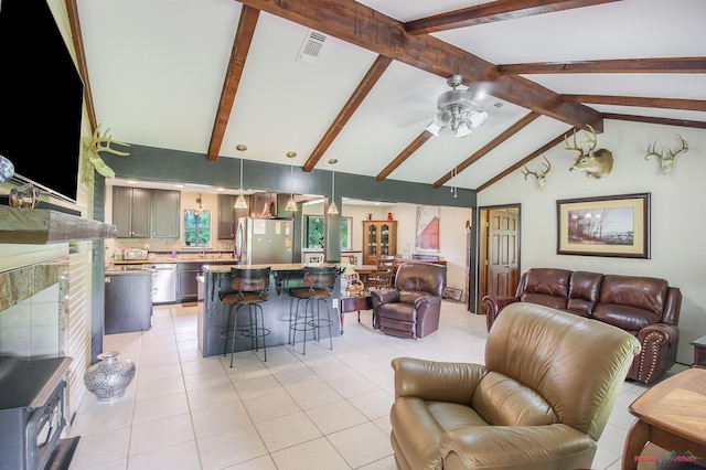 tiled living room featuring vaulted ceiling with beams and ceiling fan