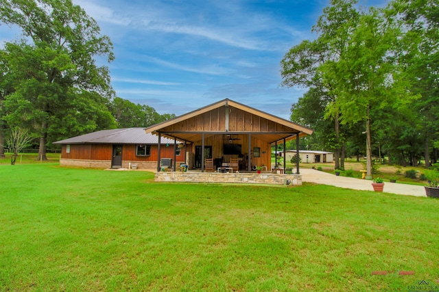 rear view of property featuring a lawn