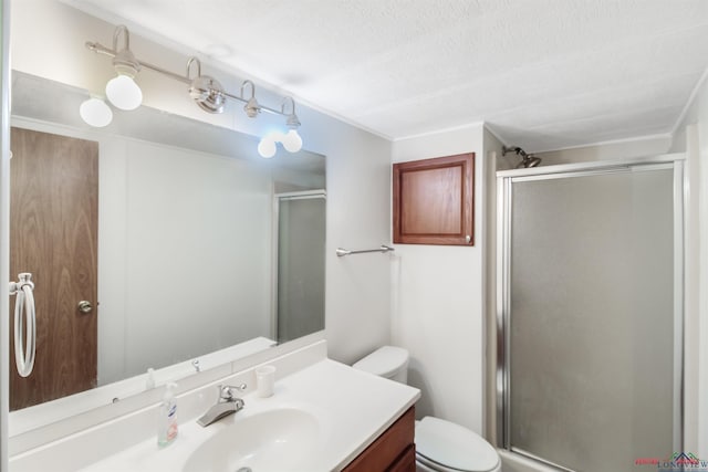 bathroom featuring toilet, an enclosed shower, a textured ceiling, and vanity