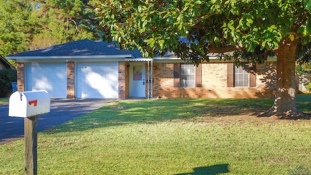 view of front of property with a front yard and a garage