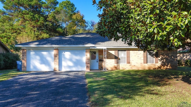 view of front of house with a garage and a front lawn