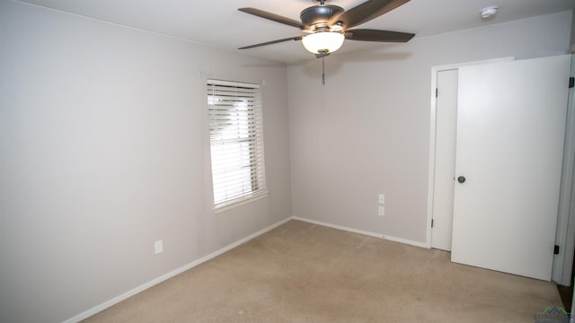 carpeted empty room with ceiling fan